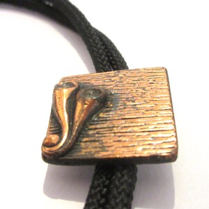 Copper Bolo Tie, Costume Copper Tone Designs Symbols onShield  Bolo Tie IC Lot 26