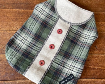 Small green plaid woollen coat with button  trim.