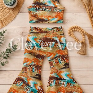 May include: A two-piece outfit consisting of a sleeveless crop top and matching bell-bottom trousers. The fabric features a vibrant, multi-coloured geometric pattern in shades of orange, turquoise, brown, and white, with a textured, speckled appearance.