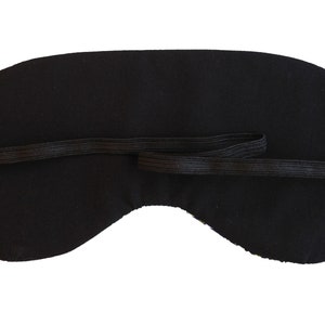 May include: Black sleep mask with an elastic strap.