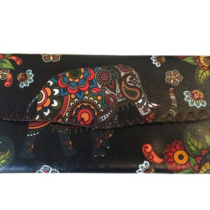 May include: A black leather wallet with a colorful paisley pattern and an elephant design. The wallet has a flap closure and a stitched edge.