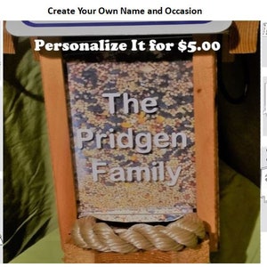 May include: Wooden bird feeder with a rope accent, filled with birdseed. The feeder has the text "The Pridgen Family" in white. Additional samples include "PAPA", "For Your New Home 2017", "#1 Mom", "In Memory Of", "#1 Dad", and "Happy Valentine's Day".