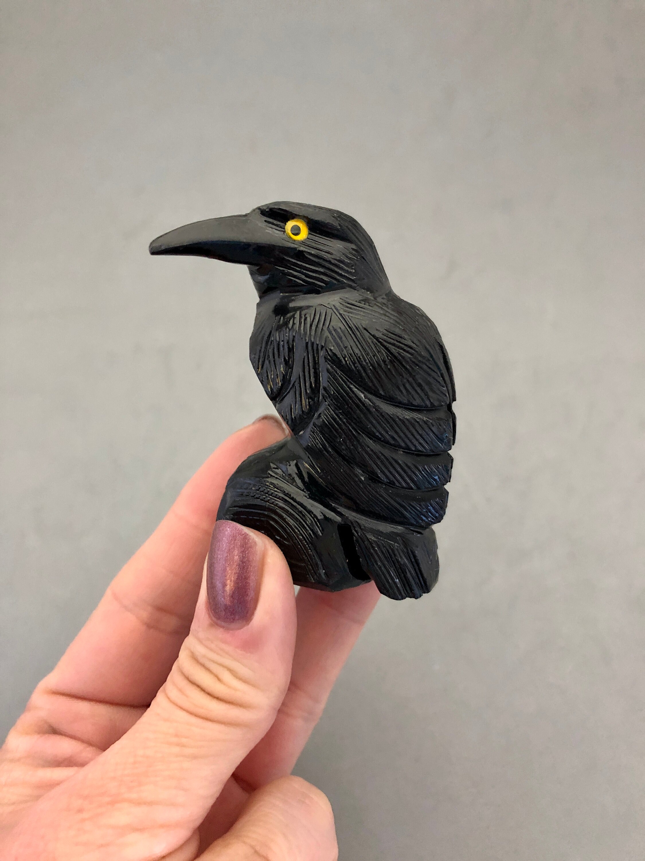 A Medium Sized Carved Black Onyx Crow with Yellow Eyes
