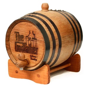May include: A small wooden barrel with black metal hoops and a wooden stand. The barrel is engraved with the text "The Godfather" and "Johnny's Bottling".