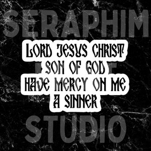 May include: A black and white sticker with the text "LORD JESUS CHRIST SON OF GOD HAVE MERCY ON ME A SINNER" in a stylized font. The word "SERAPHIM" is above the text and "STUDIO" is below. The background has a marble texture.