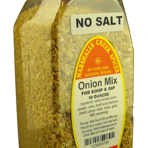 May include: A clear plastic jar with a red lid filled with a yellow onion mix. The label reads "No Salt" and "Marshalls Creek Spices" with the product name "Onion Mix for Soup & Dip" and the weight "10 ounces".