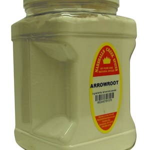 May include: A clear plastic jar with a white lid filled with white arrowroot powder. The jar has a yellow label with the text "Marshalls Creek Spices" and "Arrowroot" in red. The label also includes the ingredients and a barcode.