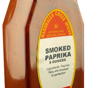 May include: A glass jar of smoked paprika with a yellow and red label that reads "Marshalls Creek Spices" and "Smoked Paprika 8 ounces". The label also includes the ingredients and instructions to reorder online.
