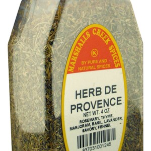 May include: A clear plastic jar filled with dried herbs labeled "Herb de Provence" by Marshalls Creek Spices. The label lists the ingredients: rosemary, thyme, marjoram, basil, lavender, savory, and fennel. The jar is 4 ounces and has a barcode and reorder information.