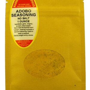 May include: A yellow pouch with a clear window showing a yellow spice blend. The pouch is labeled "Marshalls Creek Spices" and "Adobo Seasoning No Salt 1 Ounce".
