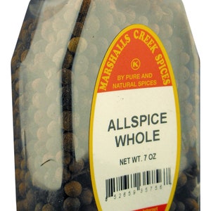 May include: A clear plastic container filled with whole allspice berries. The label reads "ALLSPICE WHOLE" and "NET WT. 7 OZ." The container has a red lid with the words "SEALED FOR YOUR PROTECTION".
