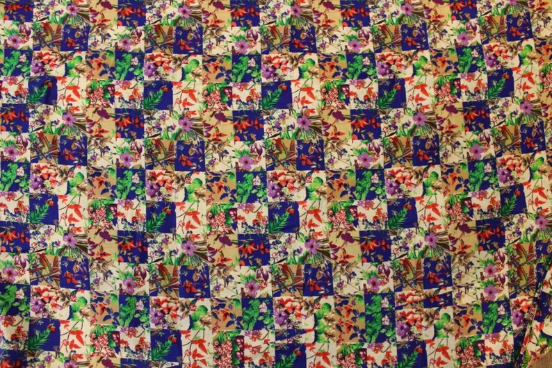 May include: A fabric with a checkered pattern featuring a variety of colourful floral designs. The fabric is a mix of white, blue, green, red, and pink.