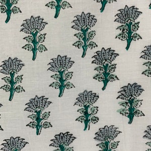 May include: White fabric with a repeating pattern of grey and green floral designs. The flowers have five petals and are on a green stem with leaves.