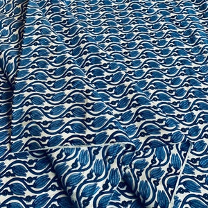 Könnte beinhalten: Blauer und weißer Baumwollstoff mit einem sich wiederholenden Muster aus stilisierten Tulpen und Blättern.