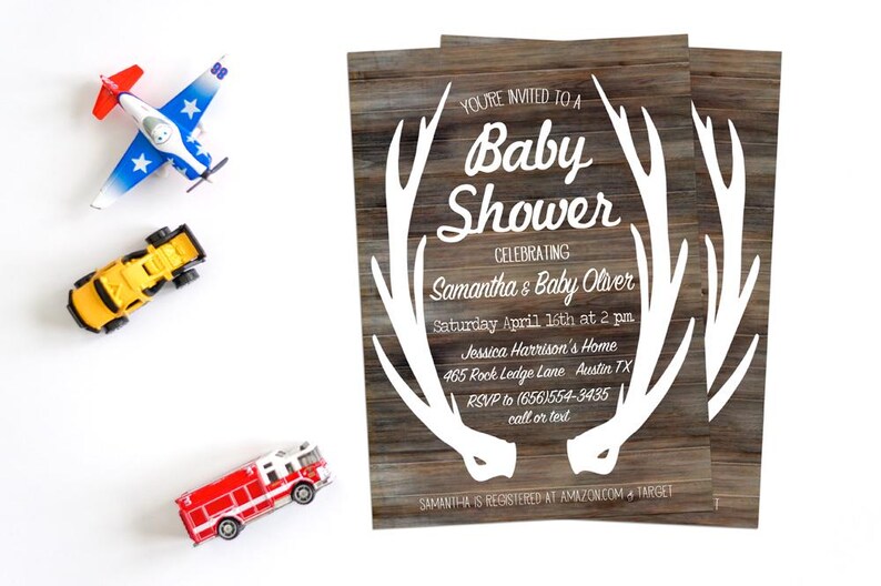 May include: A rustic woodgrain baby shower invitation with white antlers and the text "You're invited to a Baby Shower Celebrating Samantha & Baby Oliver Saturday April 16th at 2 pm Jessica Harrison's Home 465 Rock Ledge Lane Austin TX RSVP to (656)554-3435 call or text Samantha is registered at Amazon.com & Target"