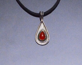 Pear Shaped Carnelian  Set on Pear Shaped Sterling Silver With A Raised Border And Blackened Background to Highlight the Stone