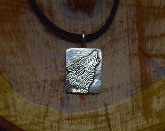 Closeup of Wolf Howling in the Wild, you can almost hear it, done in Sterlig Silver, a powerful reminder of the wild.