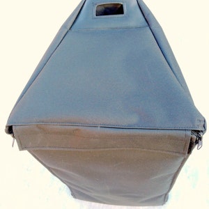 May include: Black zippered carrying case with a handle and a small rectangular opening on the top.