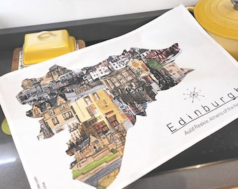 May include: White tea towel with a colorful image of the Edinburgh skyline. The text "Edinburgh" and "Auld Reekie, Athens of the North" is printed on the towel.