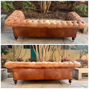 May include: A brown leather tufted sofa with a distressed finish. The sofa has a rolled back and arms, and is supported by four wooden legs.