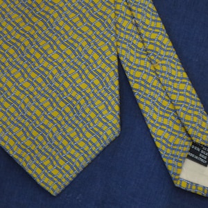 Vintage GUCCI tie with blue patterns on a golden yellow background
