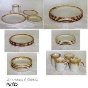 May include: Set of vintage ceramic cups and saucers with a speckled brown and white glaze. The set includes four cups and four saucers. The cups have a brown rim and the saucers have a brown rim and a brown band around the edge. The set is in good condition with no chips or cracks.