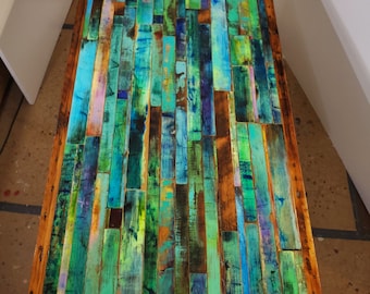 Dining table wood mosaic in emerald greens and blues.