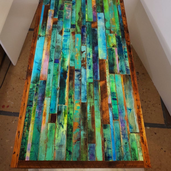 Dining table wood mosaic in emerald greens and blues.