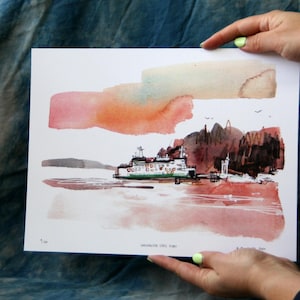 May include: Watercolor print of a ferry boat on the water, with a colorful sky and distant land. The ferry is white and green, with a detailed design. The print is held by hands.