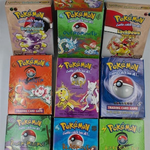 May include: A collection of nine rectangular Pokémon Trading Card Game theme deck boxes featuring various colorful character illustrations, the Pokémon logo, and titles including Brushfire, Bodyguard, Overgrowth, Lockdown, Hot Water, Zap, and Blackout.