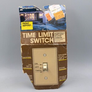 May include: An Intermatic Night Sentry time limit switch in original brown cardboard packaging. The packaging features a house graphic, text detailing automatic 15-minute shut-off, and a beige wall switch with ON, OFF, and TIMER settings visible.