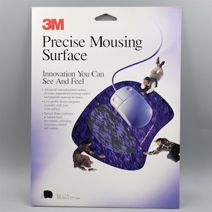 May include: A package for a 3M Precise Mousing Surface. The package features a white and purple design with the text "Precise Mousing Surface" and "Innovation You Can See And Feel". The mouse pad is 8 inches by 7 inches.