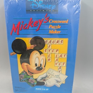 May include: A blue box for the Disney Software game Mickey's Crossword Puzzle Maker. The front features Mickey Mouse wearing a floral shirt, holding a pencil and a crossword sheet. The text reads Disney Software, Mickey's Crossword Puzzle Maker, and AGES 5 & UP.