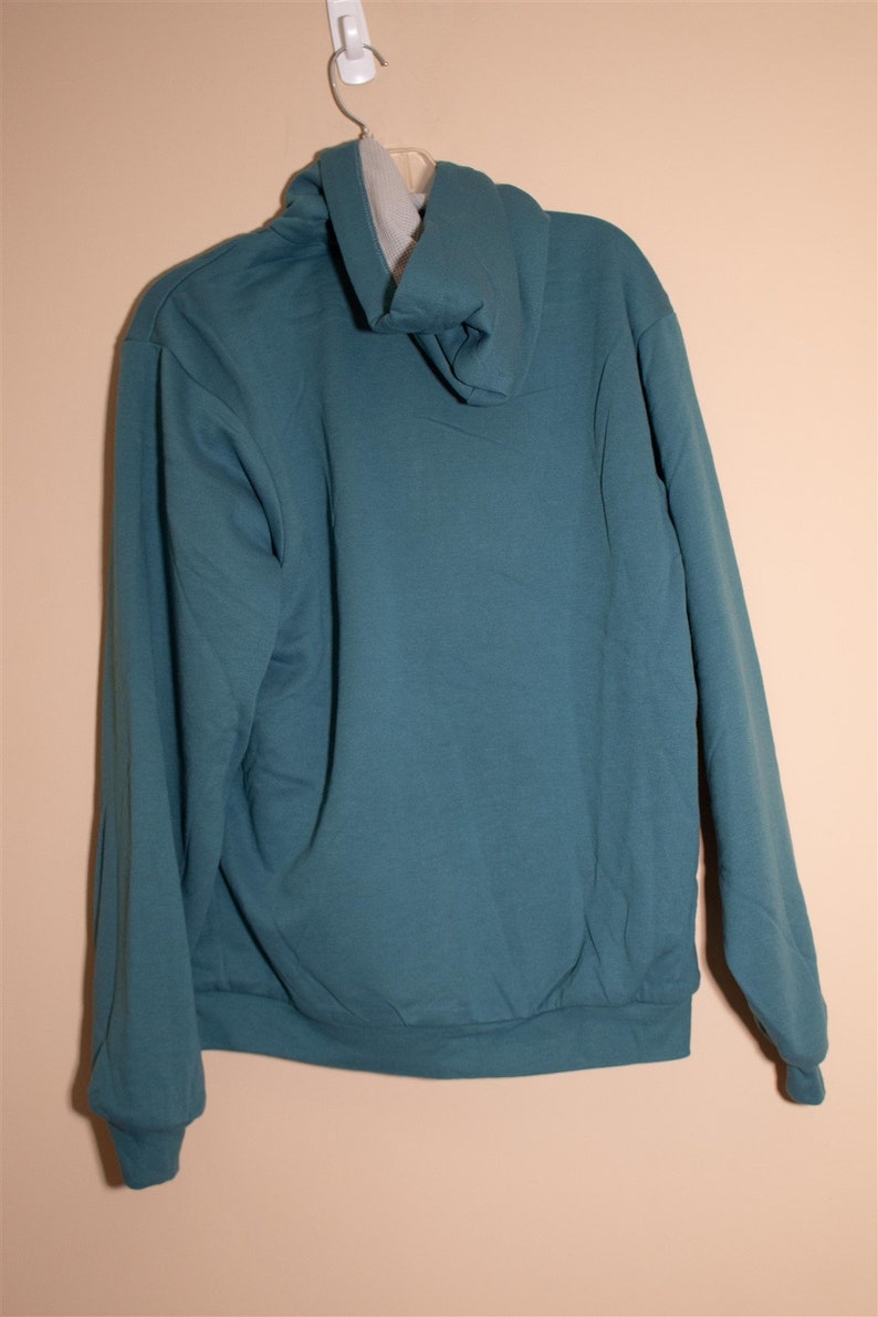 May include: A teal blue hooded sweatshirt with a drawstring hood.