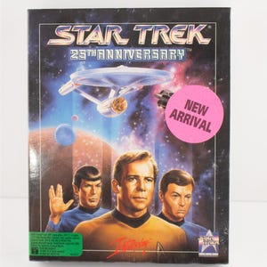 May include: A Star Trek 25th Anniversary box featuring the USS Enterprise in space, with Captain Kirk, Spock, and Dr. McCoy. A pink "New Arrival" sticker is on the front.