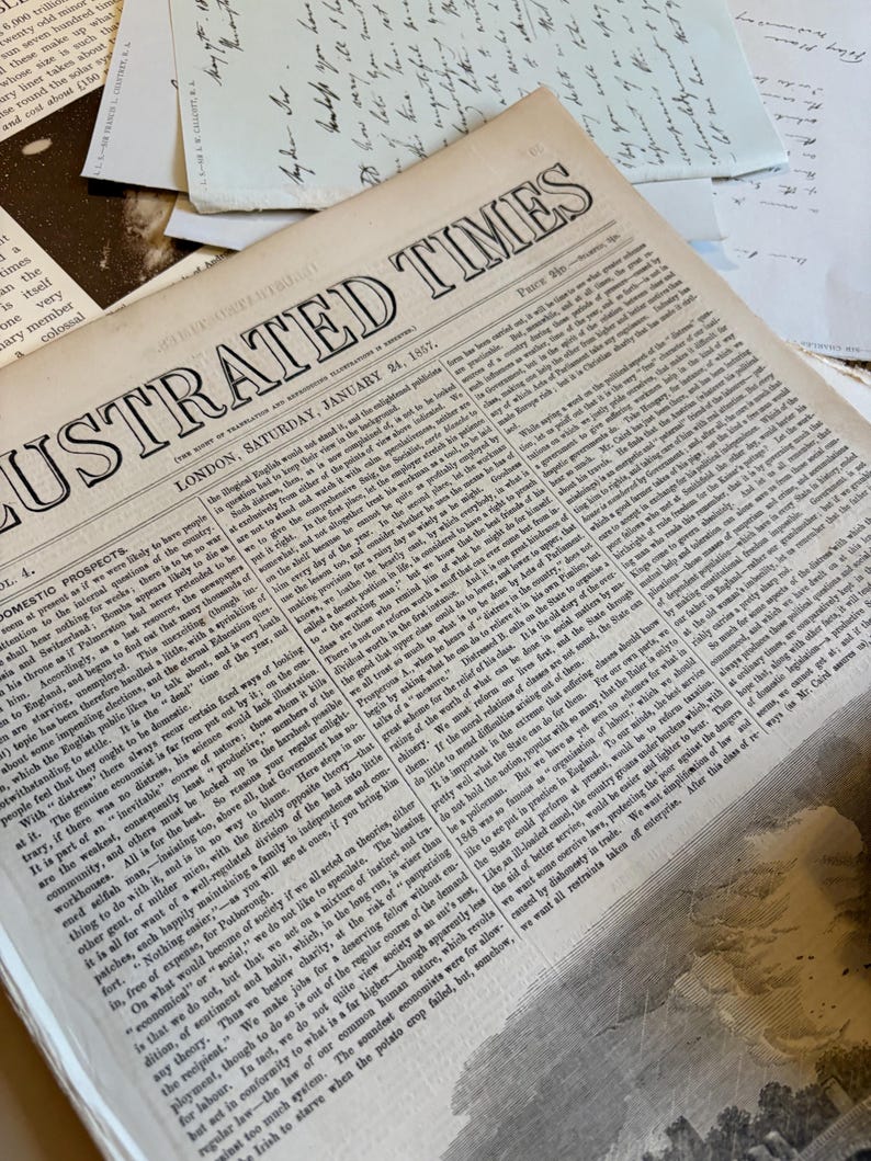Bundle of over 100 vintage and antique paper ephemera pieces, including aged letters, postcards, and documents, arranged in a flat lay on a rustic wooden surface ready for scrapbooking and paper craft projects