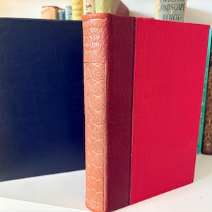 May include: A red hardback book with a gold spine and a patterned design. The book title is "The Collected Poems of Dylan Thomas".