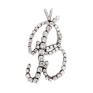 May include: A silver pendant shaped like the letter 'B' with a diamond-encrusted design.