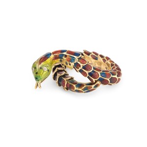May include: A gold-toned snake ring with a colorful enamel design. The snake's head is green and yellow with two small diamonds for eyes. The body is red, blue, and gold. The ring is coiled in a circular shape.