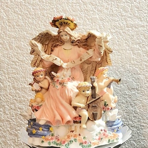 Beautiful Vintage Angel with cherubs musical Figurine