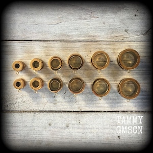 May include: A set of 12 gold-colored metal rings of varying sizes. The rings are arranged in two rows of six, with the largest rings at the top and the smallest rings at the bottom. The rings are all smooth and have a shiny finish.