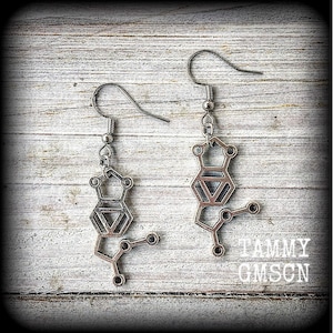 These awesome earrings feature a pair of antique silver MDMA molecules, measuring just under 5cms from tip to tip, weighing only a gram or two each.

This pair have been made with stainless steel french hooks, for pierced ears.