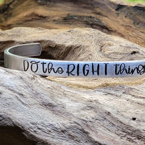 May include: Silver bracelet with the inscription "Do the right thing".