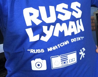 official russ lyman shirt Whatcha Doin slogan (White Lettering)