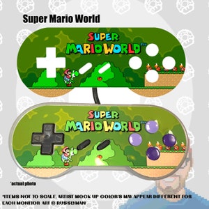 May include: Two Super Mario World game controllers. The top controller has a white plus sign and white buttons. The bottom controller has a black plus sign and purple buttons. The text "Super Mario World" is displayed on both controllers.