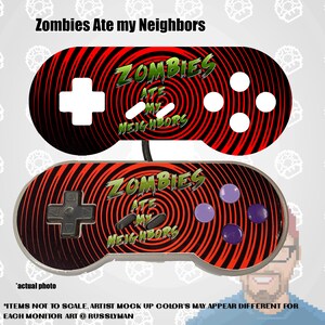 May include: Two video game controllers with a red and black spiral design. The text "Zombies Ate my Neighbors" is displayed in green and white. One controller has white buttons, the other has purple buttons.