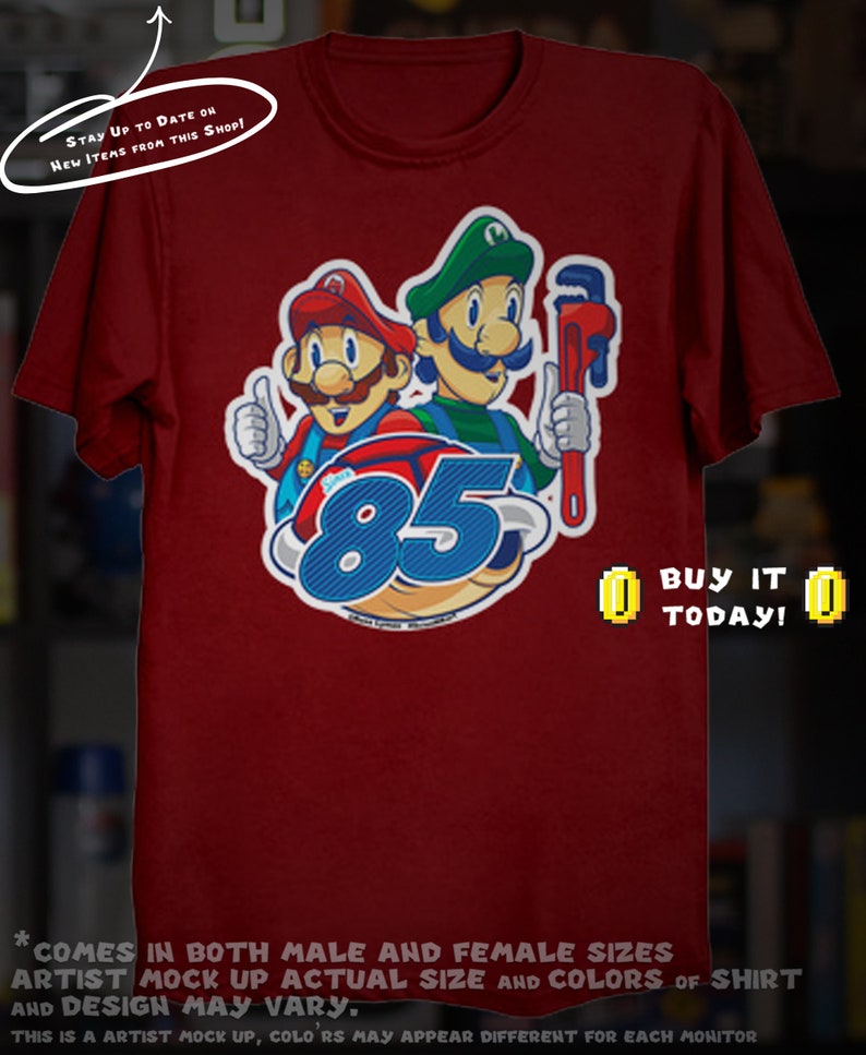 May include: Maroon t-shirt featuring a graphic of two cartoon plumbers with the number 85. One plumber gives a thumbs up. The text "BUY IT TODAY!" is displayed. The shirt has the text "STAY UP TO DATE ON NEW ITEMS FROM THIS SHOP!"