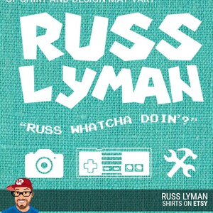May include: Teal-colored shirt design featuring the name "RUSS LYMAN" in bold white letters. Below, the phrase "RUSS WHATCHA DOIN'?" is displayed. The design includes camera, game controller, and wrench icons. The bottom text reads "RUSS LYMAN SHIRTS ON ETSY."