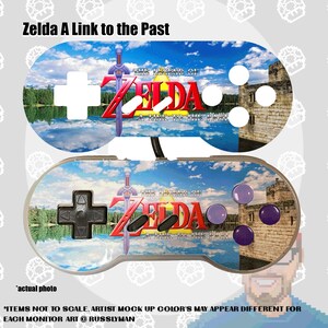 May include: A custom video game controller featuring artwork from "The Legend of Zelda: A Link to the Past." The controller has a sky and water background with the game's logo and a sword. The controller has white, black, and purple buttons.