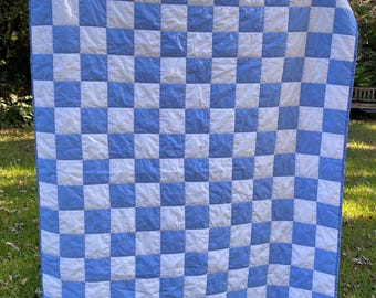 May include: A blue and white checkered quilt with a simple design. The quilt is made of cotton fabric and has a soft, comfortable feel.